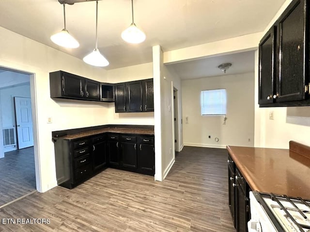 kitchen with pendant lighting, light hardwood / wood-style flooring, and white gas stove