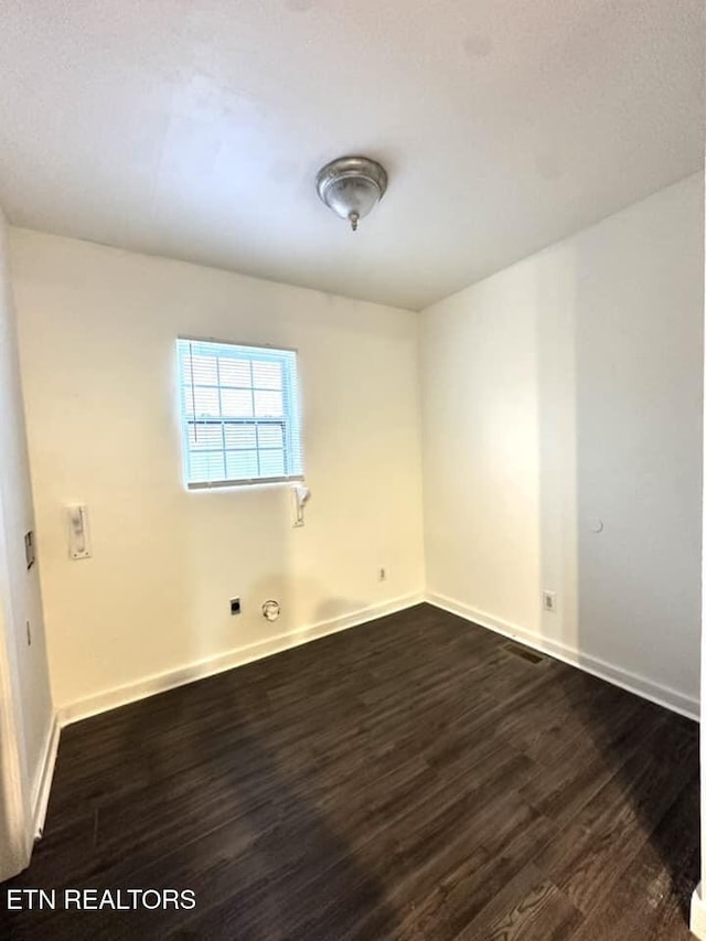 empty room featuring dark wood-type flooring