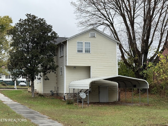 view of side of property with a carport and a lawn