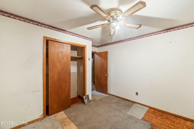 unfurnished bedroom with carpet flooring, a textured ceiling, a closet, and ceiling fan