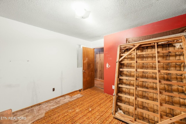 unfurnished room with a textured ceiling and electric panel