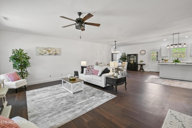 living room featuring dark hardwood / wood-style flooring and ceiling fan