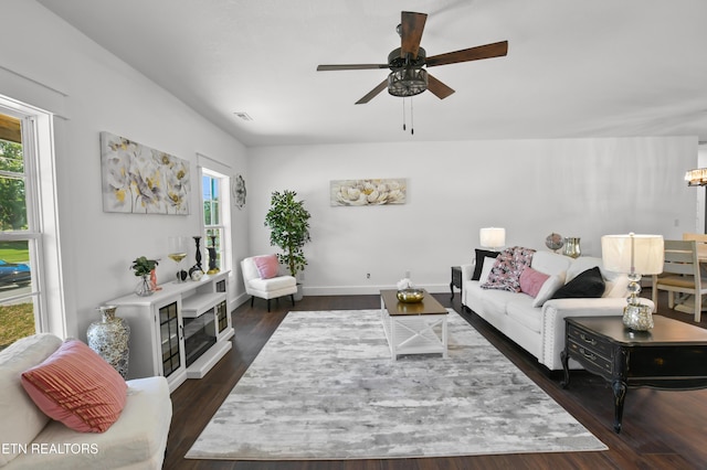 living room featuring ceiling fan and dark hardwood / wood-style flooring