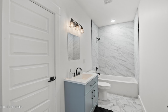 full bathroom with vanity, tiled shower / bath combo, and toilet