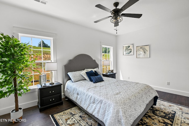 bedroom with ceiling fan and dark hardwood / wood-style flooring