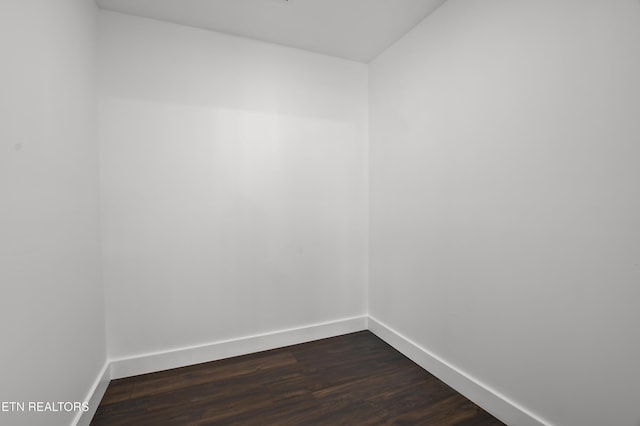 unfurnished room featuring dark wood-type flooring