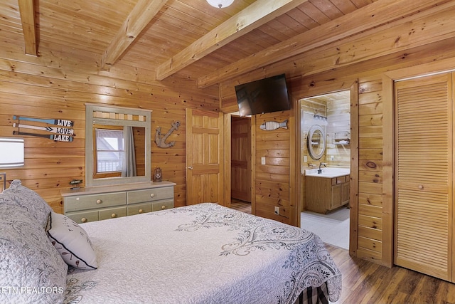 bedroom with beam ceiling, light hardwood / wood-style flooring, wood ceiling, and wood walls