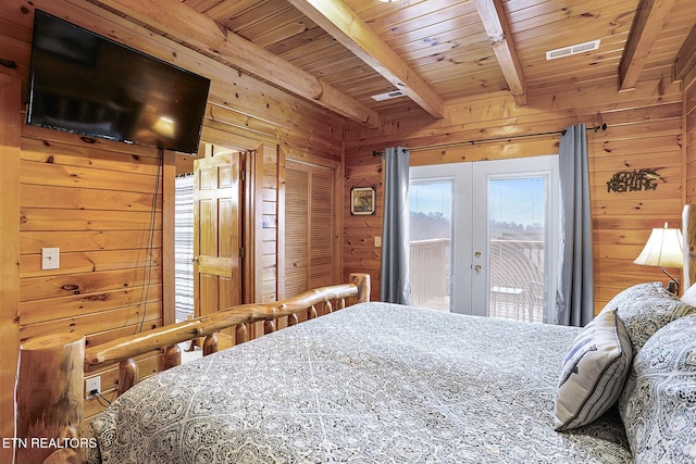 bedroom featuring access to exterior, beam ceiling, french doors, and wooden walls