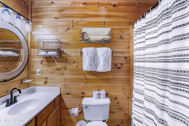 bathroom with vanity, toilet, wood ceiling, and wood walls