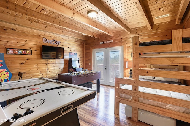 recreation room featuring hardwood / wood-style flooring, wooden walls, and wood ceiling