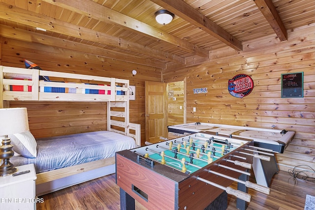 bedroom featuring beam ceiling, wooden walls, dark wood-type flooring, and wood ceiling