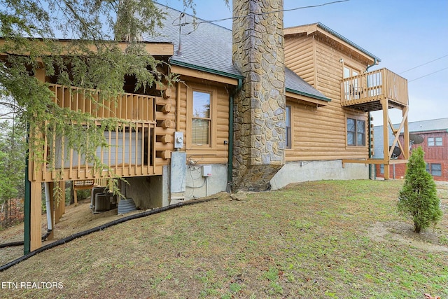 back of property featuring a balcony and central air condition unit