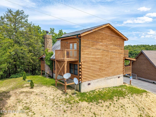 2626 Camden Way, Sevierville, TN 37876 - view of home's exterior with log siding, a balcony, a chimney, and crawl space