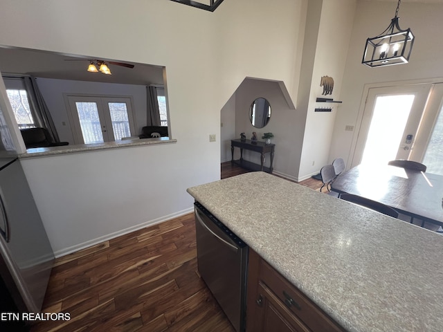 kitchen with dishwasher, french doors, dark wood-type flooring, decorative light fixtures, and ceiling fan with notable chandelier