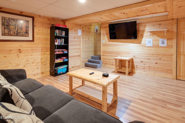 living room featuring wood walls and hardwood / wood-style flooring