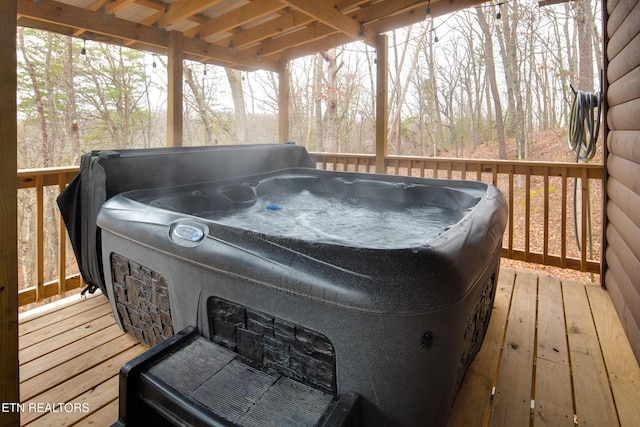 wooden deck featuring a hot tub