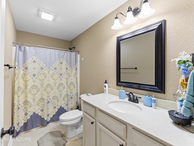 bathroom with tile patterned floors, vanity, toilet, and a shower with curtain