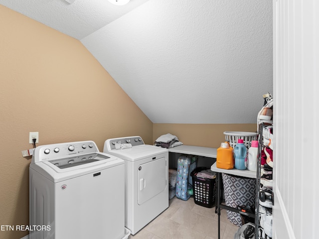 washroom with separate washer and dryer and a textured ceiling