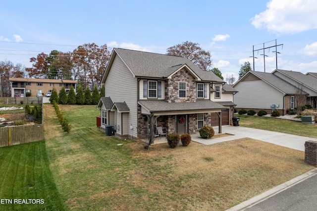 view of front of house with central AC unit and a front yard