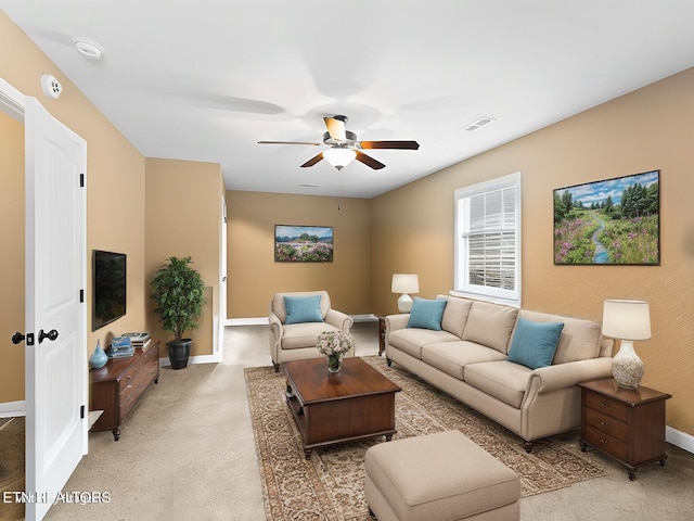 carpeted living room with ceiling fan