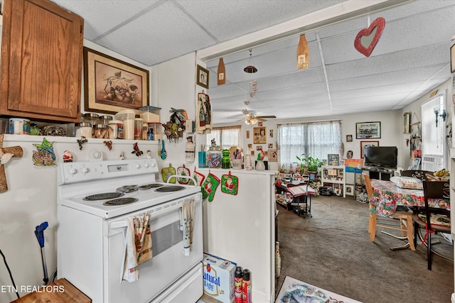 kitchen with carpet, electric range, a drop ceiling, and ceiling fan