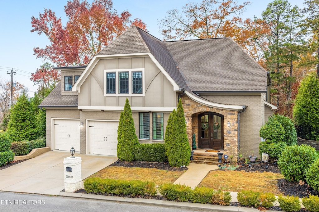 1807 Argyle Ct, Ooltewah, TN 37363 - view of front of property featuring a shingled roof, concrete driveway, board and batten siding, and a garage
