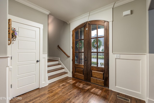 entryway with crown molding, french doors, and dark hardwood / wood-style floors