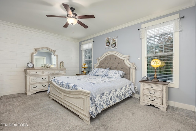 bedroom with ceiling fan, crown molding, and light colored carpet