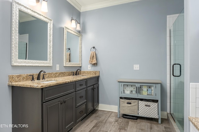 bathroom with crown molding, vanity, a shower with shower door, and hardwood / wood-style flooring