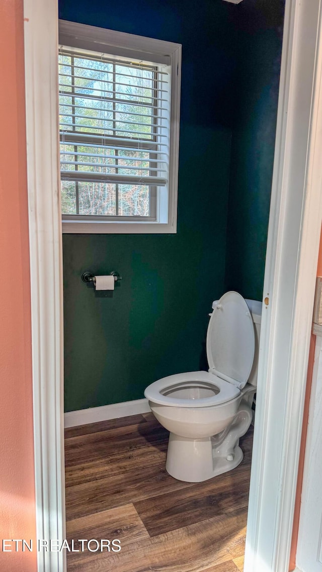 bathroom featuring hardwood / wood-style flooring and toilet