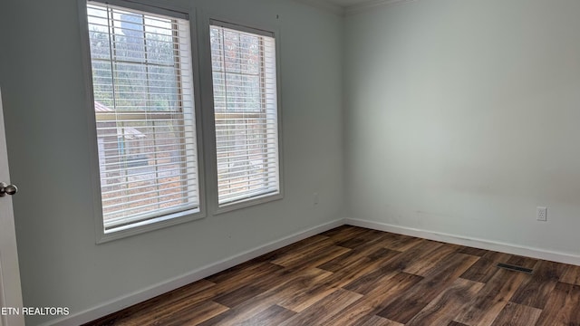 unfurnished room featuring dark hardwood / wood-style flooring and plenty of natural light