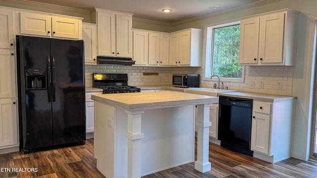 kitchen with white cabinets, black appliances, a center island, dark hardwood / wood-style flooring, and sink