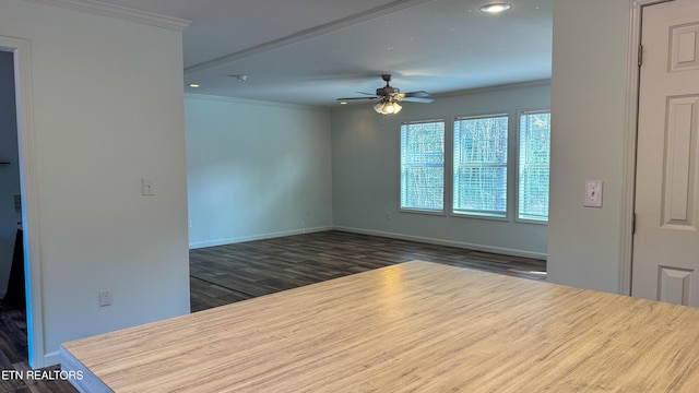 unfurnished room with ceiling fan, dark hardwood / wood-style flooring, and ornamental molding