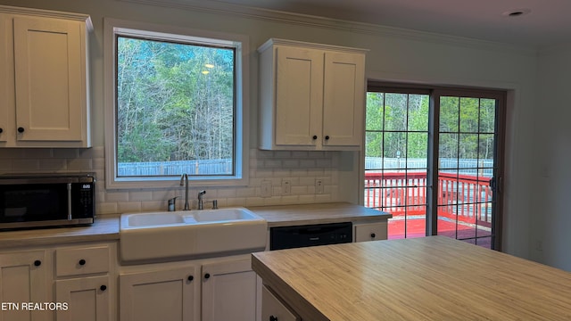 kitchen with white cabinets, sink, and ornamental molding