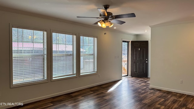 foyer entrance with ceiling fan, ornamental molding, and dark wood-type flooring