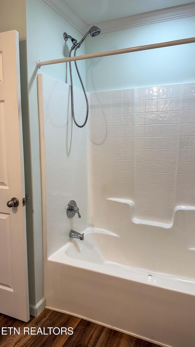 bathroom featuring hardwood / wood-style flooring and shower / washtub combination