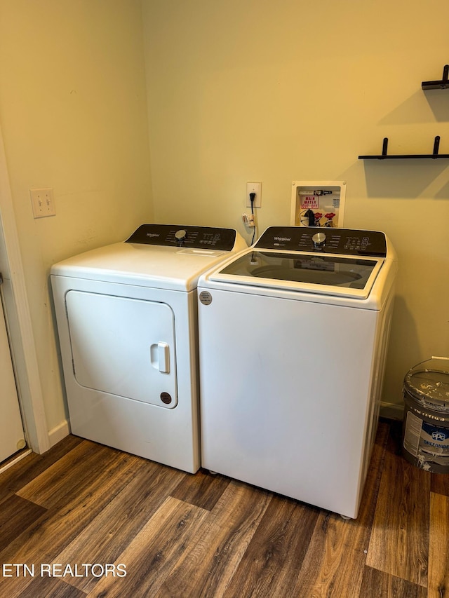 clothes washing area featuring separate washer and dryer and dark hardwood / wood-style flooring