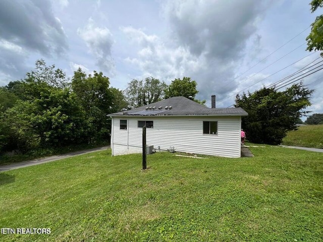 view of side of home with a lawn