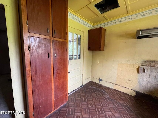 laundry area featuring dark parquet floors