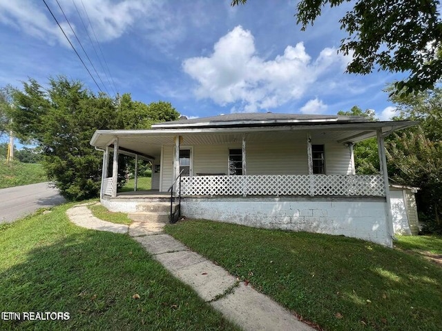 view of front of home featuring covered porch and a front yard