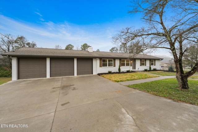 ranch-style home with a front lawn and a garage