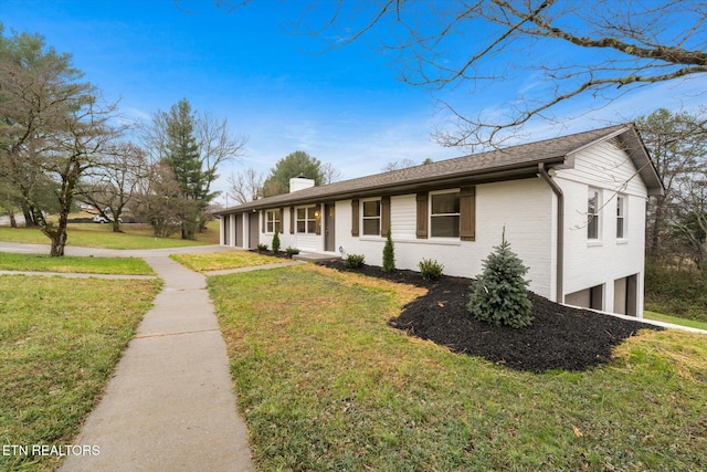 single story home with a garage and a front lawn