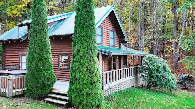 view of side of home with covered porch