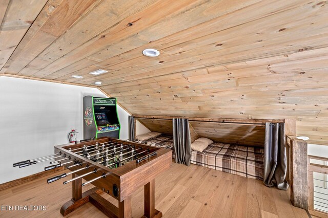 game room featuring lofted ceiling, wood ceiling, and light hardwood / wood-style flooring