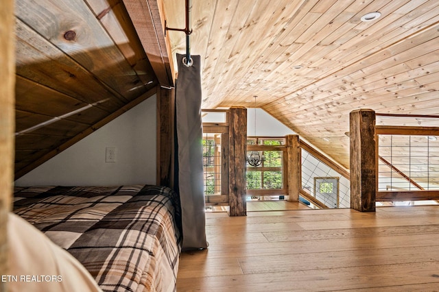 unfurnished bedroom with wooden ceiling, lofted ceiling, and light hardwood / wood-style floors