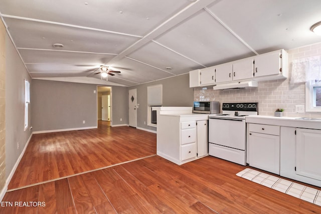 kitchen featuring light hardwood / wood-style floors, electric range oven, and white cabinetry