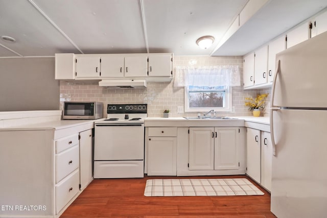 kitchen featuring hardwood / wood-style floors, white cabinets, white appliances, and sink