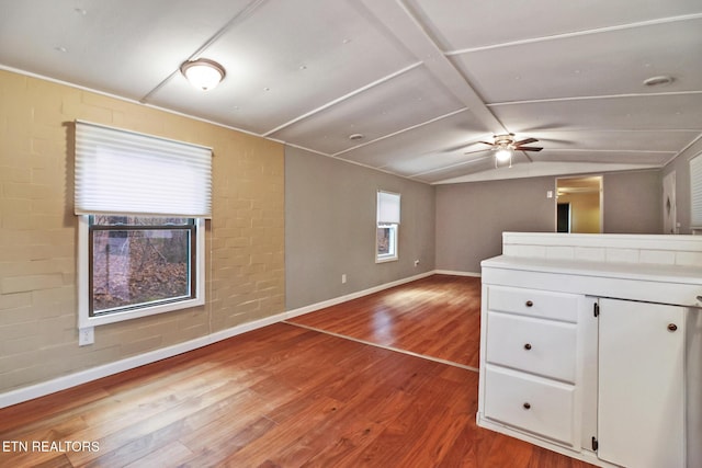 interior space with hardwood / wood-style flooring, ceiling fan, and vaulted ceiling