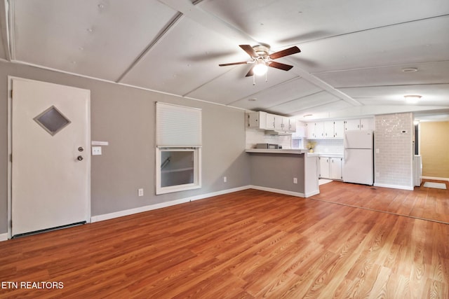 unfurnished living room with light hardwood / wood-style flooring, ceiling fan, and lofted ceiling