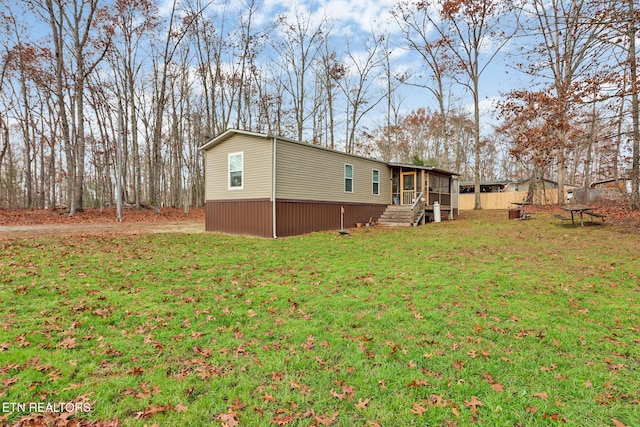 exterior space featuring a lawn and a sunroom